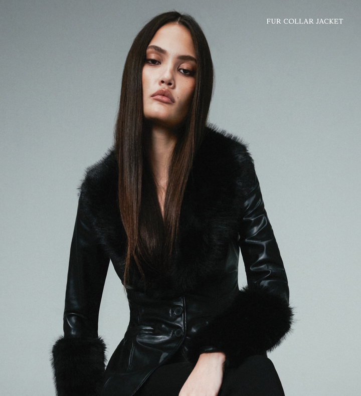 Woman wearing a black WeWoreWhat fur collar jacket against a gray background
